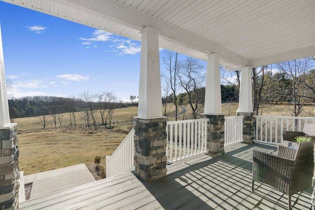 deck featuring a porch and a rural view