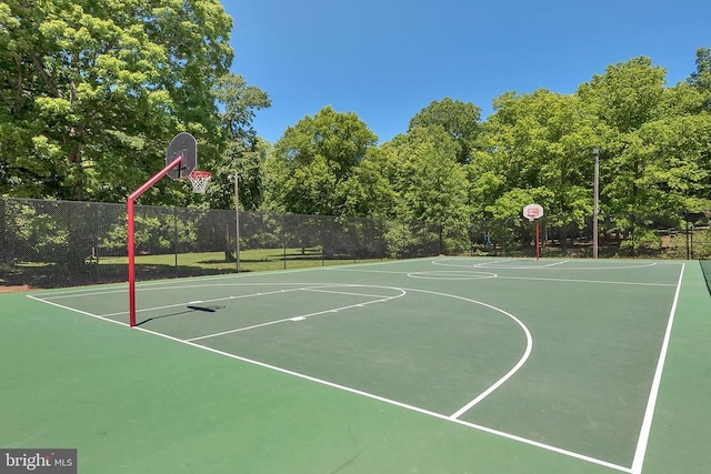 view of basketball court featuring community basketball court and fence