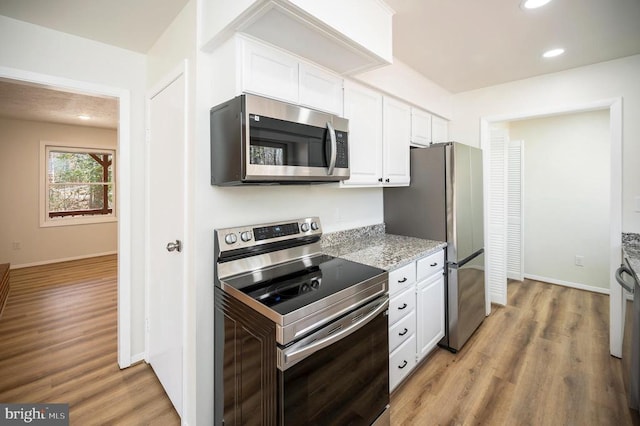 kitchen featuring recessed lighting, stainless steel appliances, light wood-style flooring, and white cabinetry