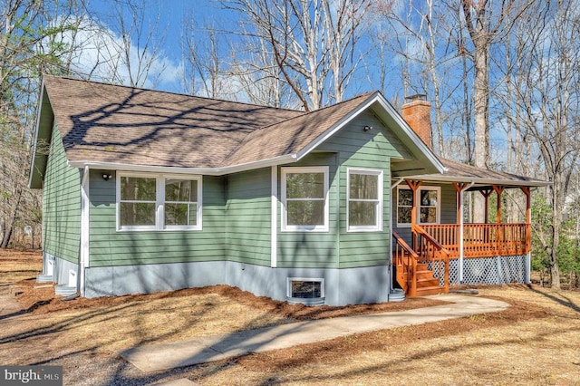 manufactured / mobile home featuring a shingled roof and a chimney