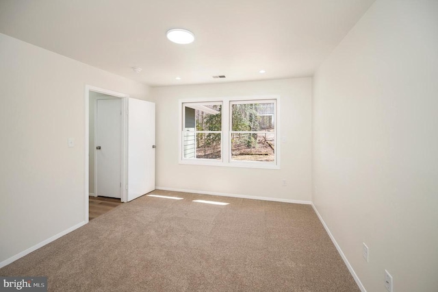 empty room with baseboards and carpet floors