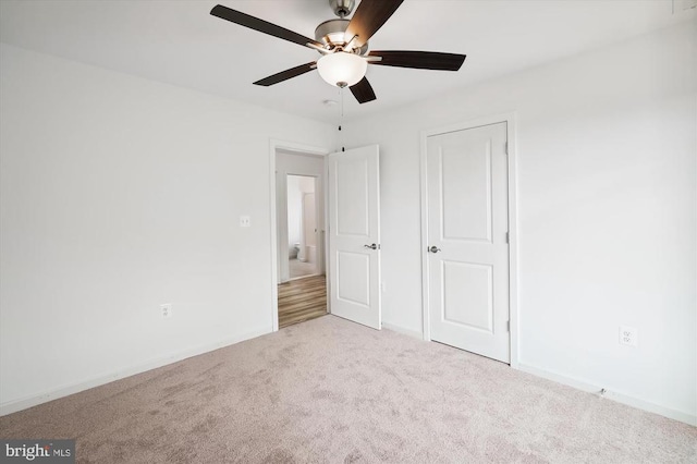 unfurnished bedroom with ceiling fan, baseboards, and carpet