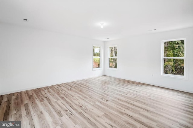 empty room with light wood-style floors and baseboards