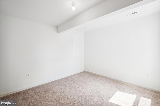 empty room with visible vents, beamed ceiling, baseboards, and carpet floors