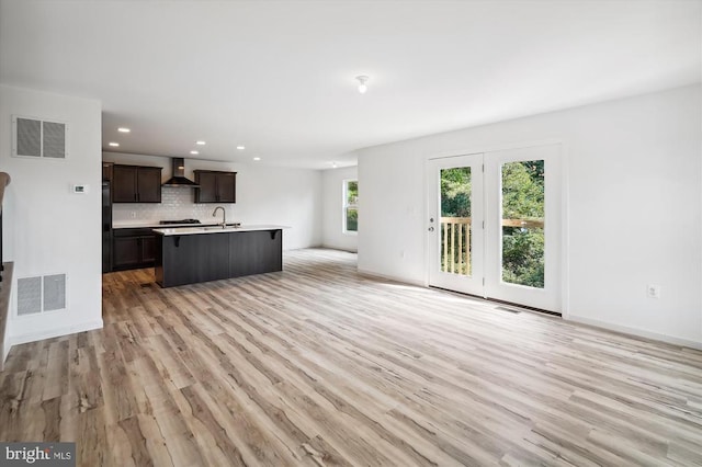 interior space featuring recessed lighting, visible vents, light wood finished floors, and baseboards