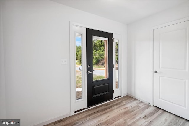 entrance foyer featuring baseboards and light wood-style floors