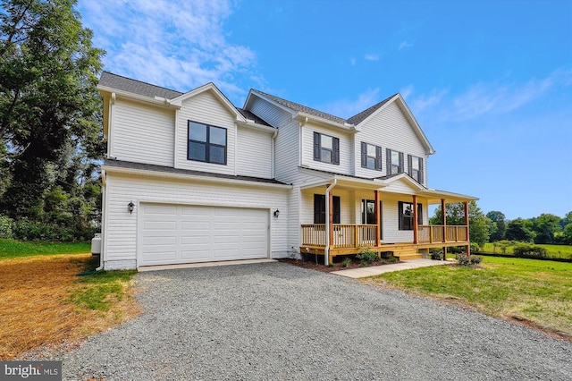 view of front of property with a garage, a front lawn, covered porch, and driveway