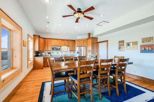 dining space with light hardwood / wood-style floors and ceiling fan