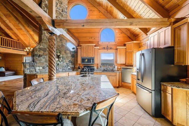 kitchen featuring appliances with stainless steel finishes, stone countertops, beamed ceiling, sink, and light tile patterned floors