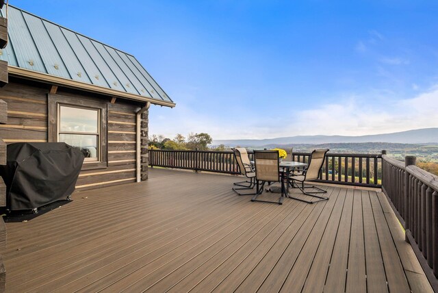 wooden deck with a mountain view and grilling area