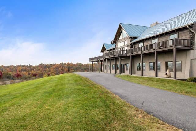 exterior space featuring a wooden deck and a yard