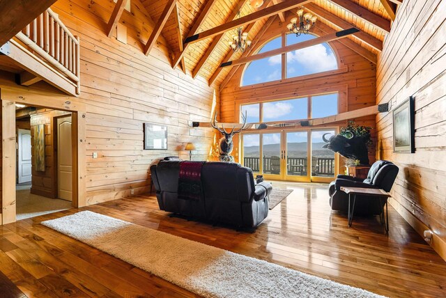 living room featuring a mountain view, wooden ceiling, a notable chandelier, and wood walls