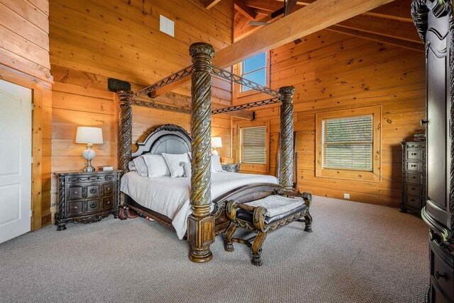 carpeted bedroom with high vaulted ceiling, beamed ceiling, and wood walls