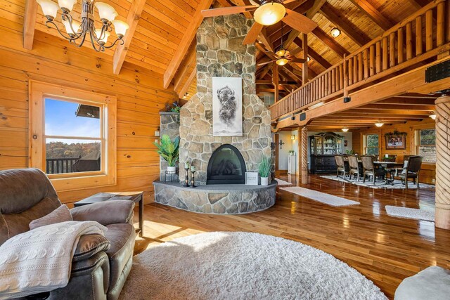 living room with hardwood / wood-style floors, wooden ceiling, and a fireplace