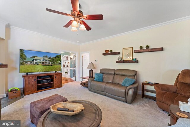 living room with carpet, baseboards, a ceiling fan, and crown molding