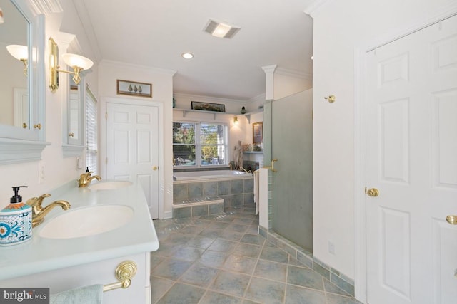 bathroom featuring a garden tub, crown molding, visible vents, and a sink