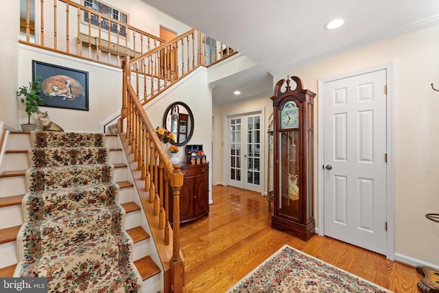 interior space with recessed lighting, crown molding, baseboards, and wood finished floors