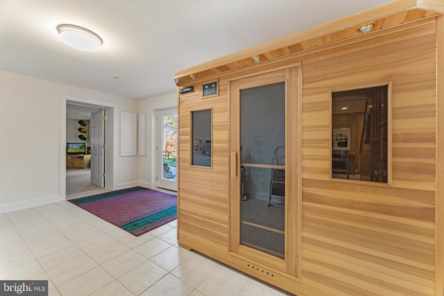 interior space featuring baseboards and tile patterned floors