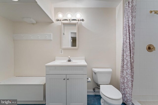 full bath featuring a stall shower, tile patterned flooring, vanity, and toilet