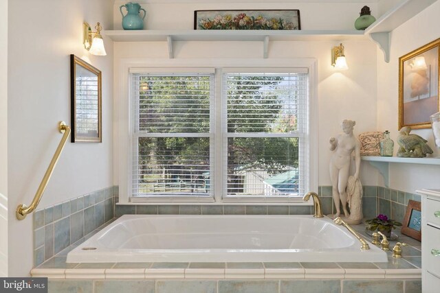 full bath with a bath and a wealth of natural light