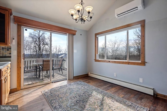 dining space with an AC wall unit, lofted ceiling, dark hardwood / wood-style flooring, baseboard heating, and an inviting chandelier