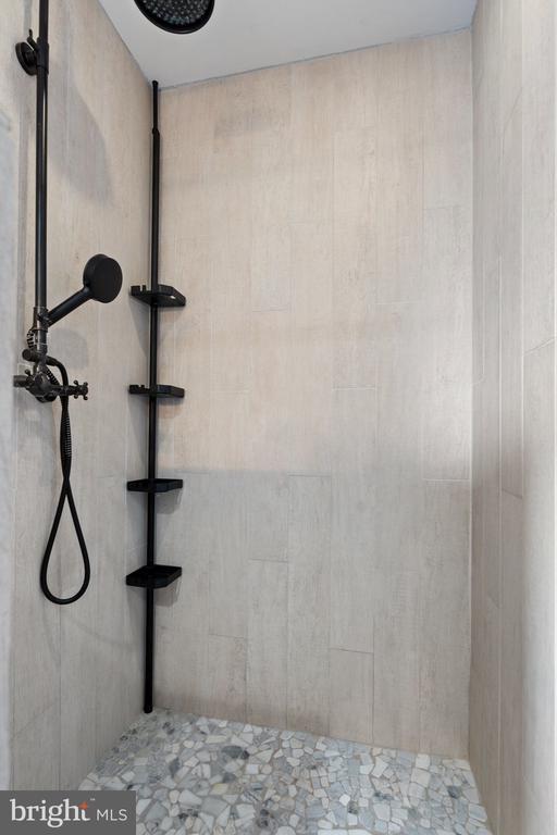 bathroom with tiled shower