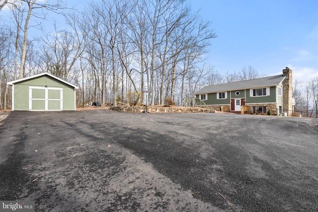 exterior space featuring a garage and an outdoor structure