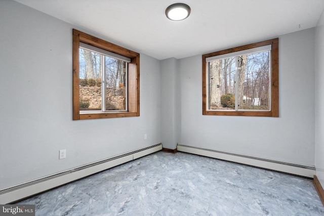 spare room with baseboard heating and plenty of natural light