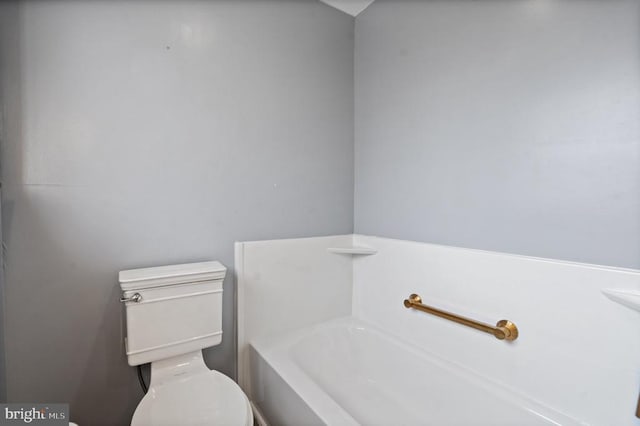 bathroom featuring a tub and toilet