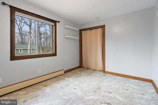 unfurnished bedroom with a baseboard heating unit