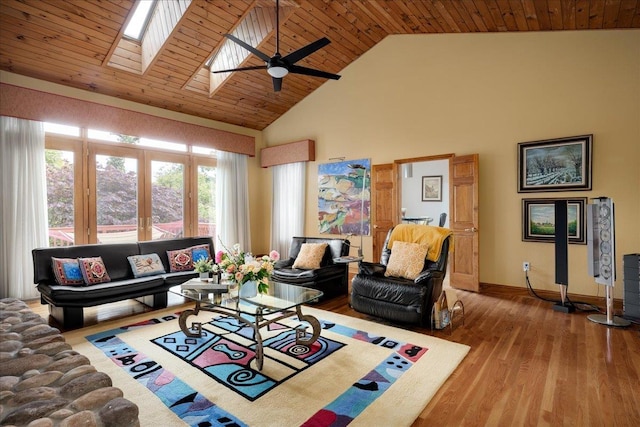 living room with hardwood / wood-style floors, high vaulted ceiling, a skylight, wood ceiling, and french doors