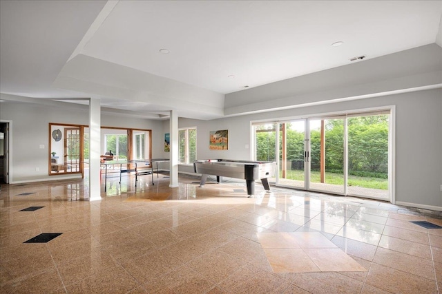 recreation room featuring a raised ceiling