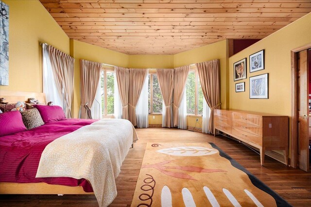 bedroom with vaulted ceiling, light wood-type flooring, and wood ceiling