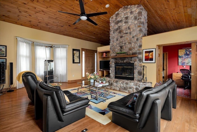 living room featuring lofted ceiling, light wood-type flooring, wood ceiling, and a fireplace