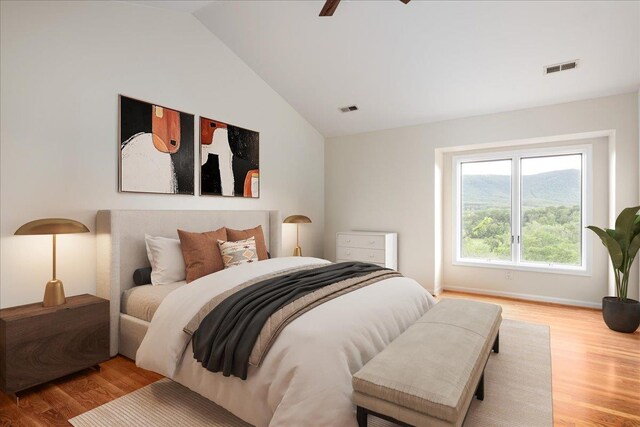 bedroom with lofted ceiling, wood-type flooring, and ceiling fan