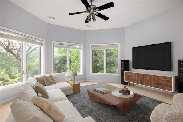 living room with a healthy amount of sunlight and ceiling fan