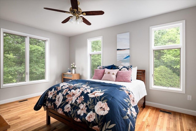 bedroom with wood-type flooring and ceiling fan