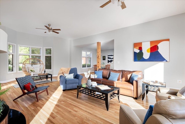 living room with ceiling fan and light wood-type flooring