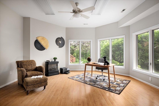 home office with ceiling fan, a healthy amount of sunlight, and light wood-type flooring