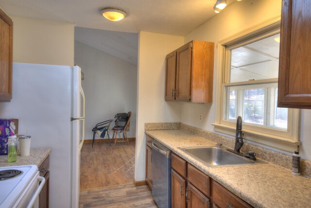 kitchen featuring electric stove, stainless steel dishwasher, wood-type flooring, and sink