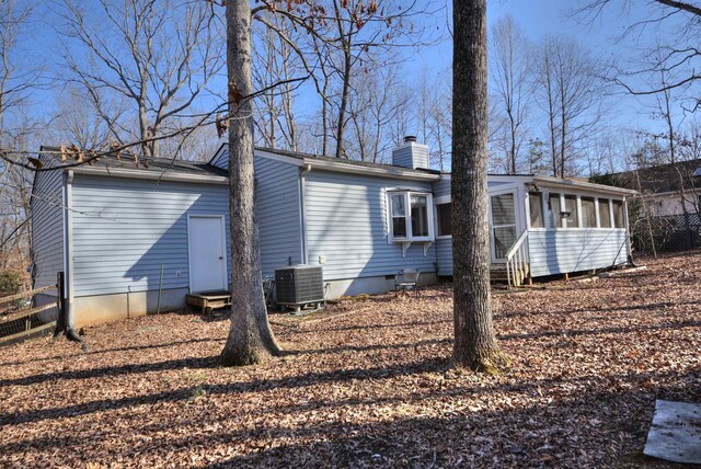 back of house with cooling unit and a sunroom