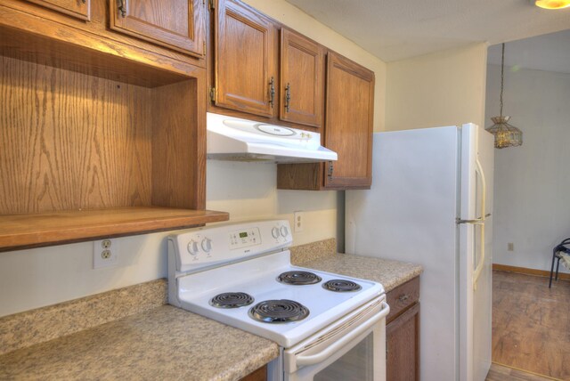 kitchen with hardwood / wood-style flooring and white appliances