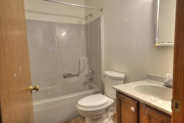 full bathroom featuring vanity, toilet, and  shower combination