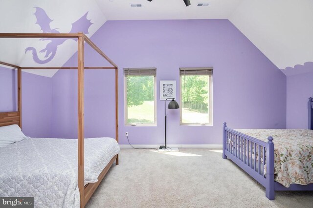 carpeted bedroom with lofted ceiling