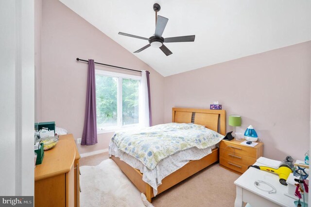 bedroom with light carpet, lofted ceiling, and ceiling fan