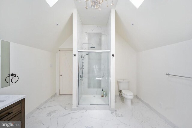 bathroom with vanity, toilet, vaulted ceiling with skylight, and walk in shower