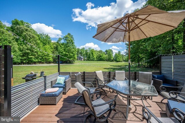 wooden terrace featuring a yard