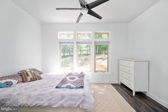 bedroom with ceiling fan and dark hardwood / wood-style floors