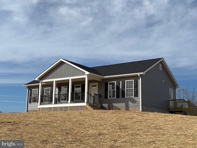 view of front of property featuring covered porch and roof with shingles