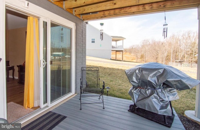 wooden terrace with a grill